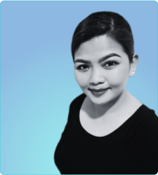 A woman in a black shirt stands poised for a photo, exuding confidence and elegance in her pose.