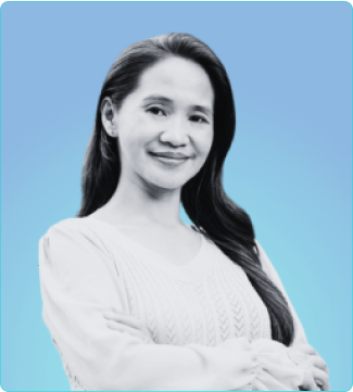 A smiling woman with long hair dressed in a white shirt exudes happiness and confidence.